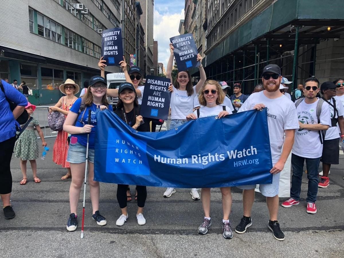 students hold banner at a disability pride parade