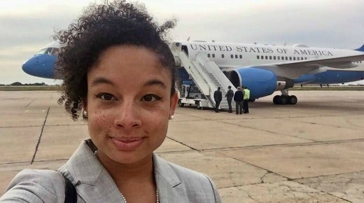 Photo of a young woman, Kristin Smith, standing in front of Air Force One