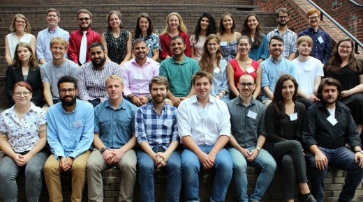 A group photo of the MAAS class of 2020 sitting on the brick steps outside CCAS