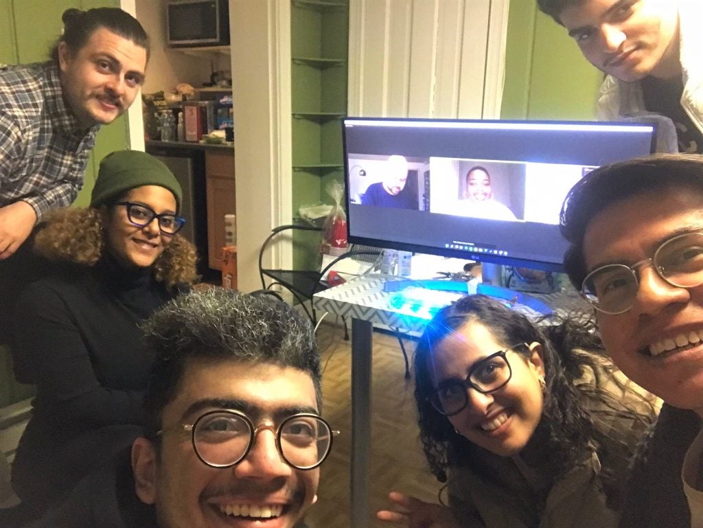 Students gathered around a computer screen