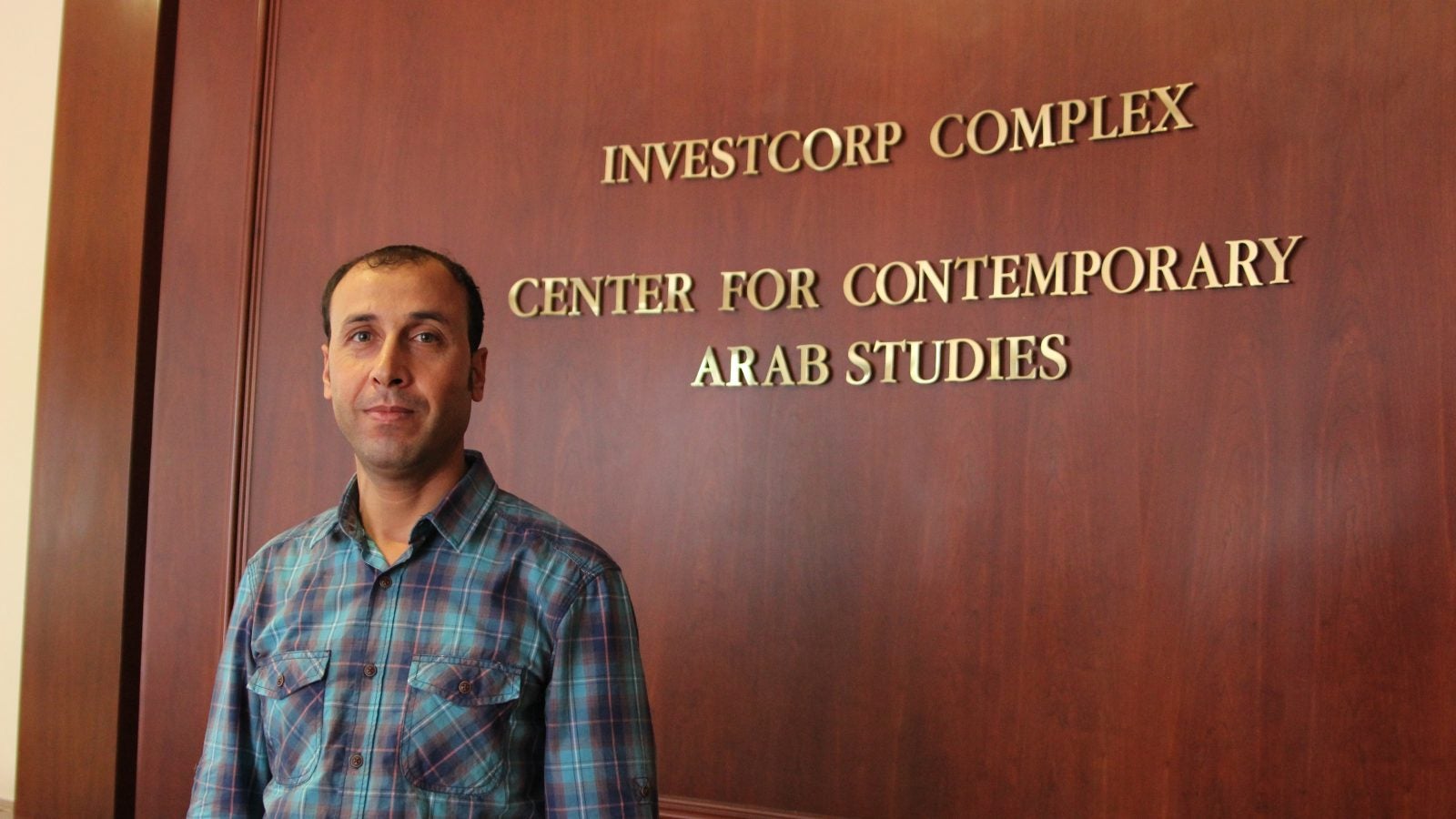 Professor Mohammad AlAhamd in front of the the CCAS sign