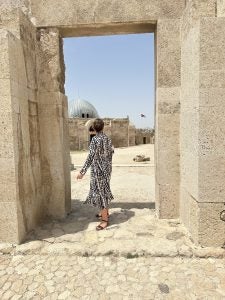 Molly standing in stone doorway in Jordan