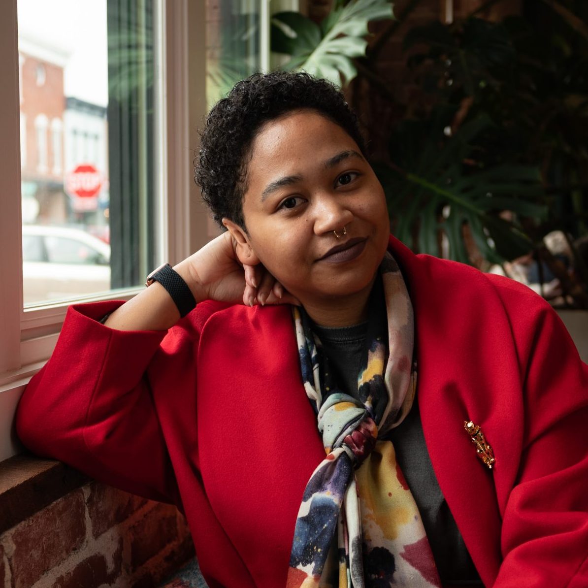 Anela Malik sitting near a window