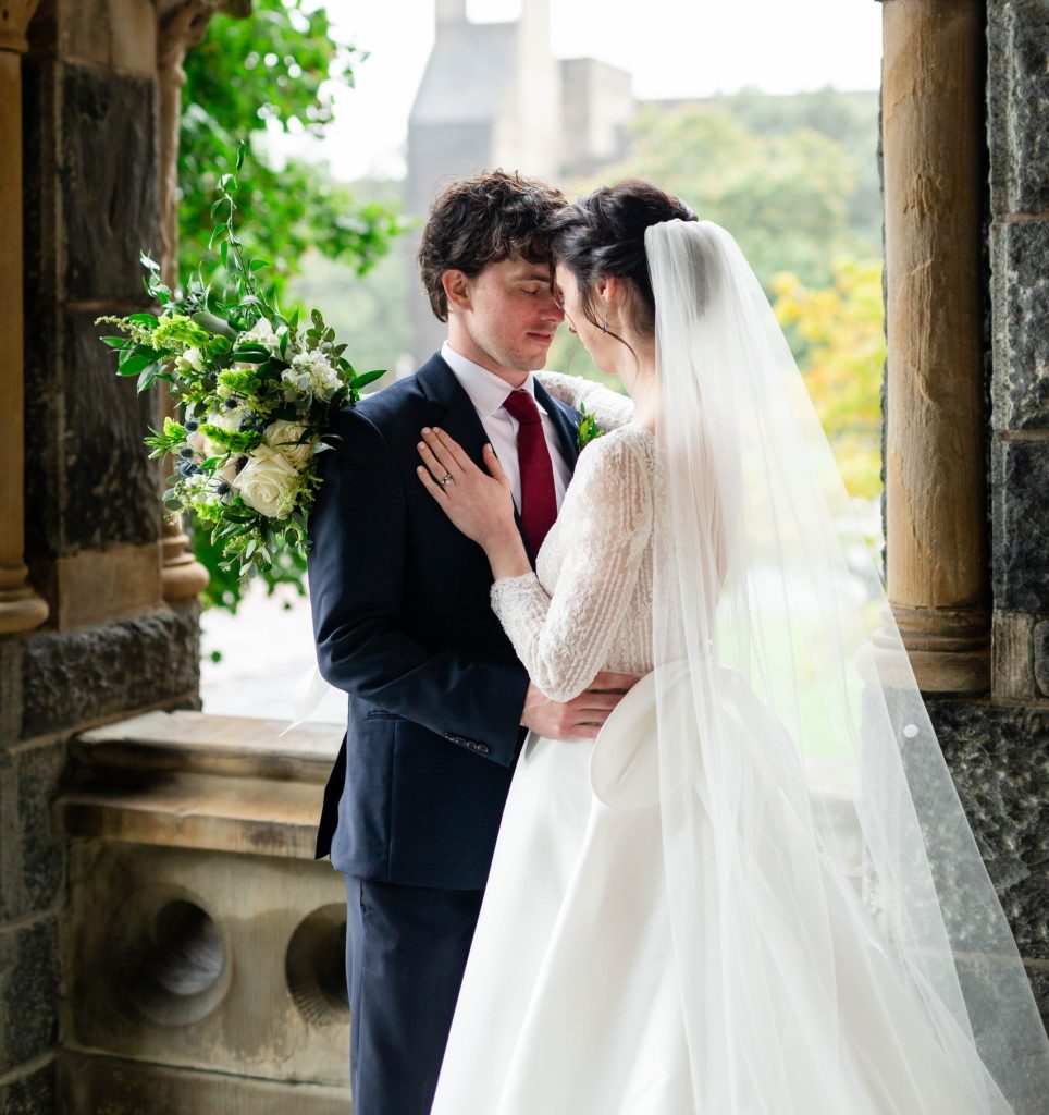 Mark and Meghan share a dance during their wedding at Georgetown University. Mark is wearing a suit and Meghan is wearing a wedding dress.