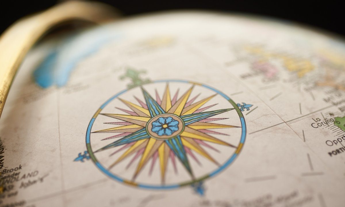 Close-up of North Star compass on a globe