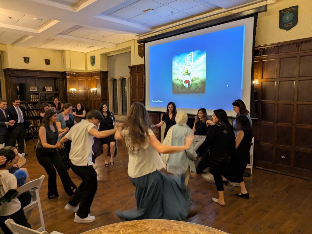Students join a debke line at the CCAS Community Dinner, one of the anniversary year's culminating events